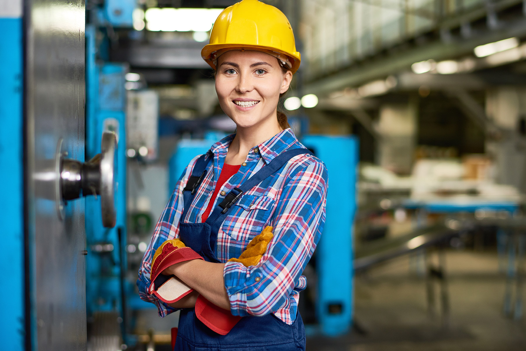 happy-young-woman-working-at-factory-DWN33CH.jpg